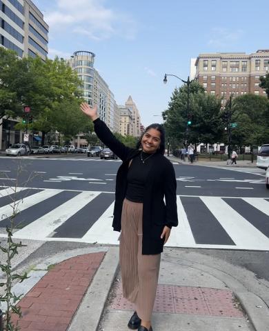 Deida Cortez waving in the middle of a street.