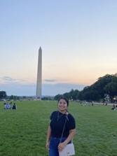 Berenice standing in the National Mall, with the Washington Monument in the background.