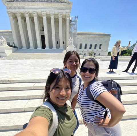 Luz standing in front of the Supreme Court building.